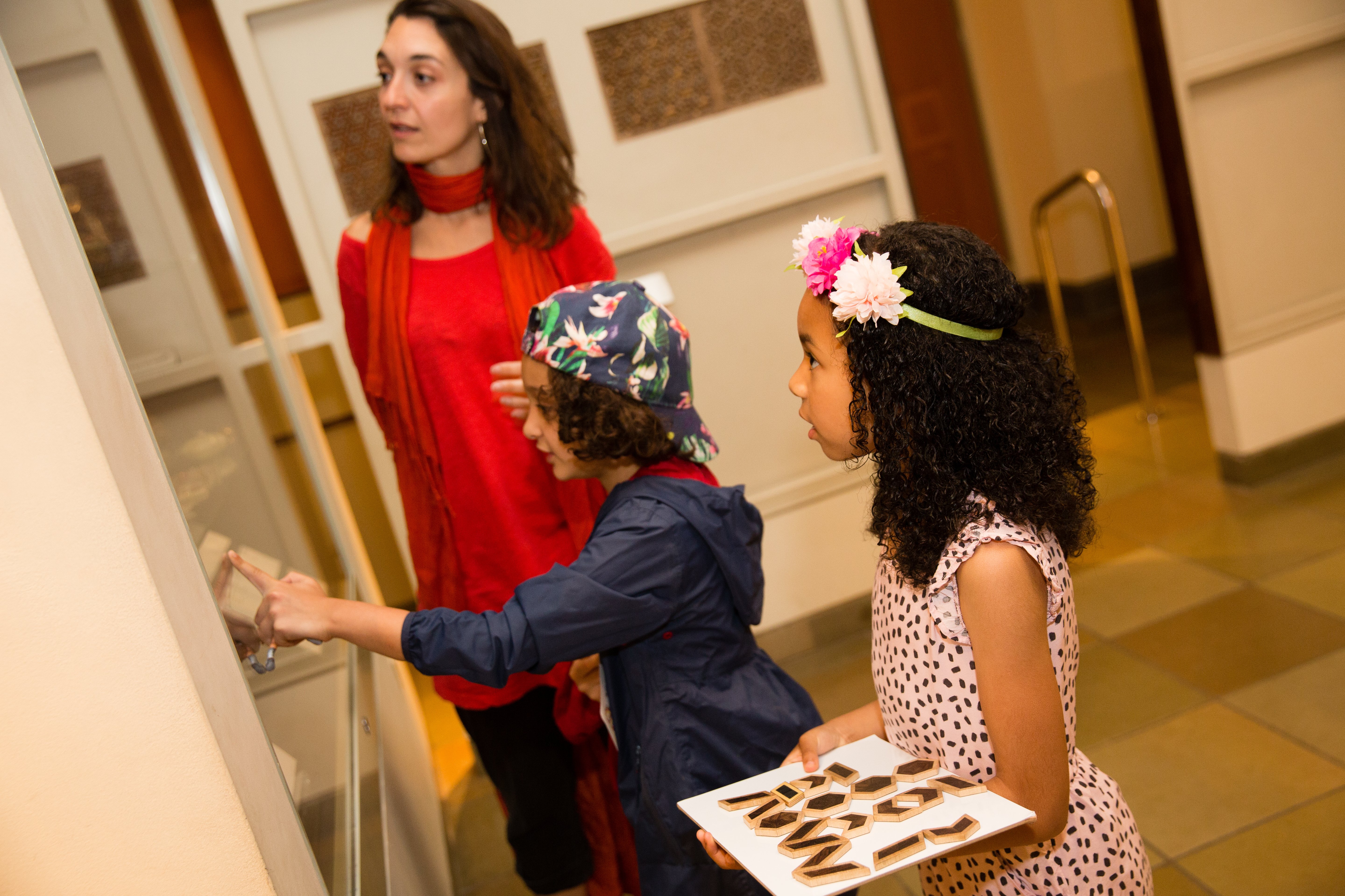 Two children viewing objects in a glass cabinet at the museum