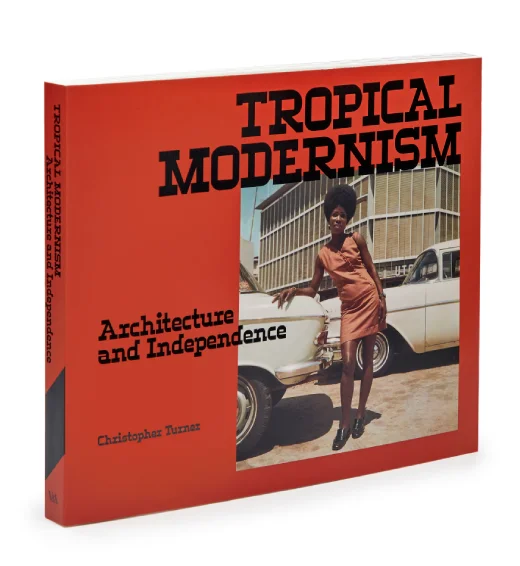 A paperback with an orange cover and the title Tropical Modernism in black letters. 