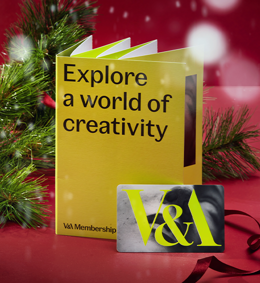 A lime green membership pack propped on a red background with Christmas accents