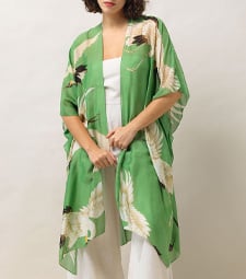 A model wearing a sheer green throw over.